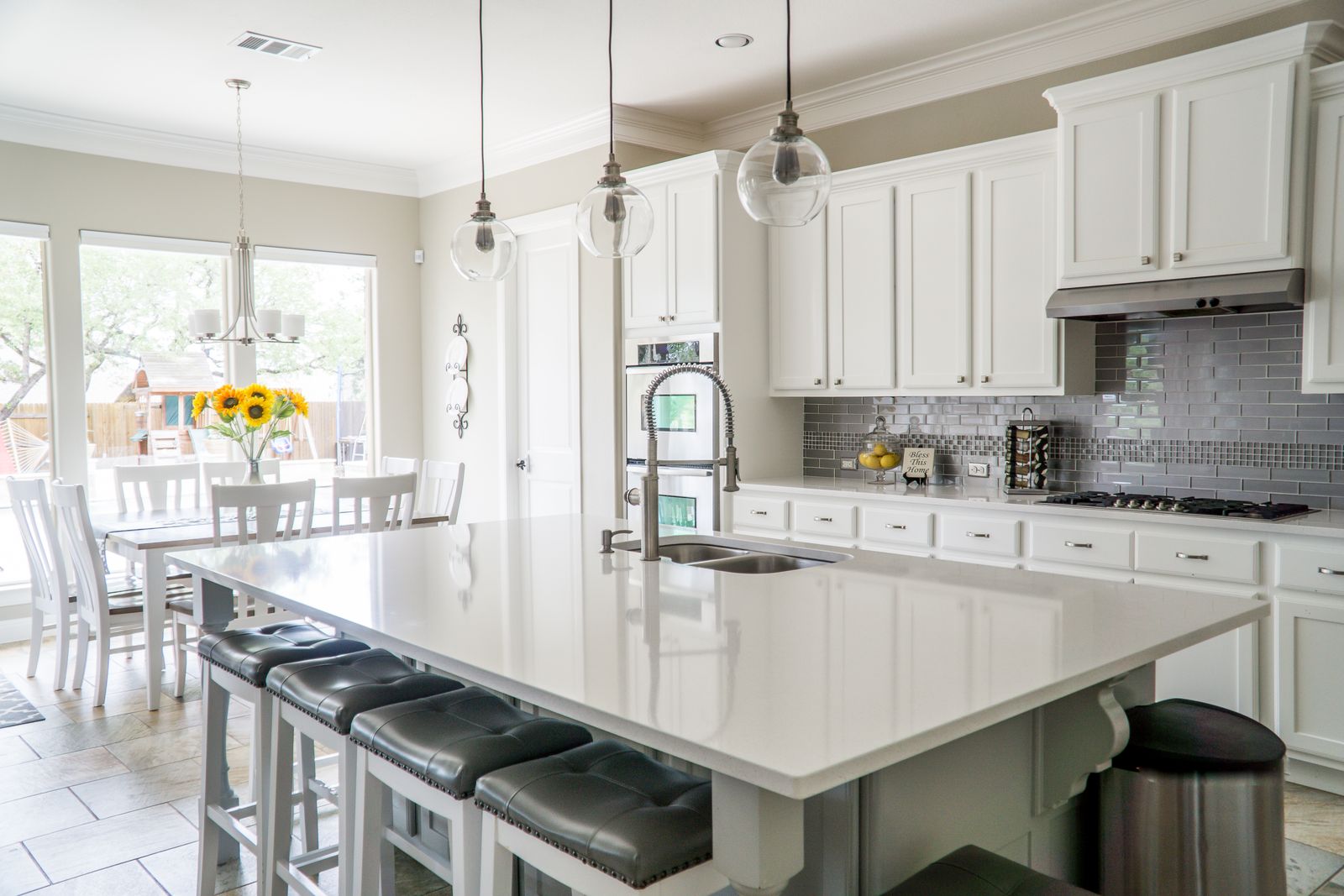 Bright white kitchen with a polished island and spotless counters